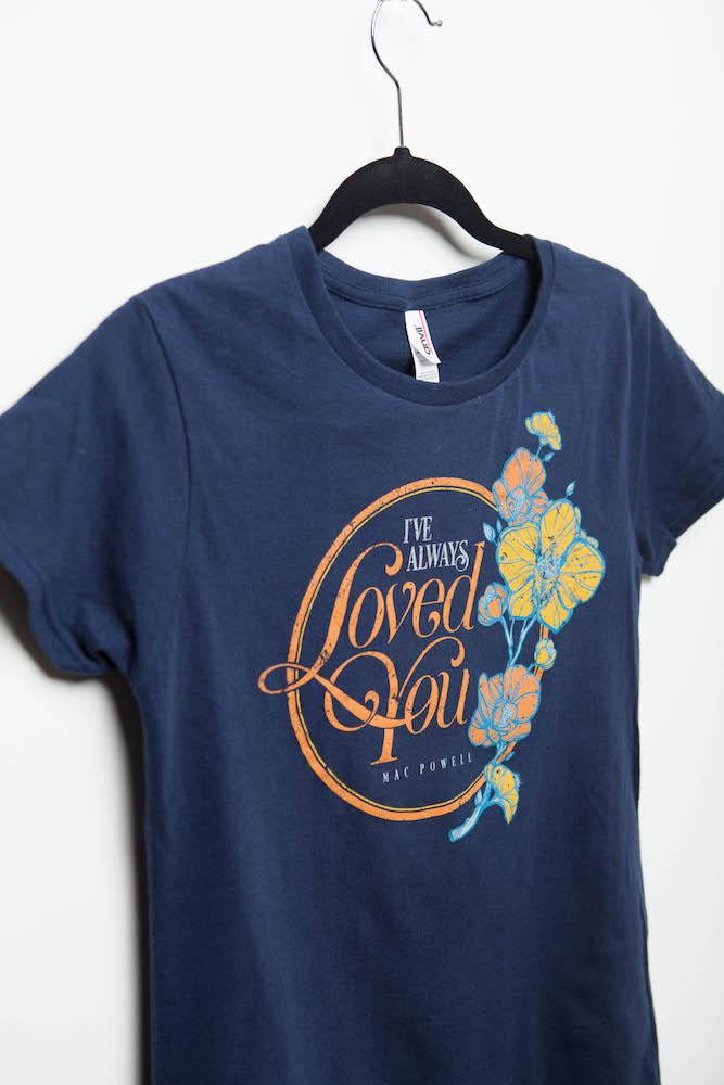 Close up of a navy blue ladies Mac Powell tee that reads "I've Always Loved You - Mac Powell."